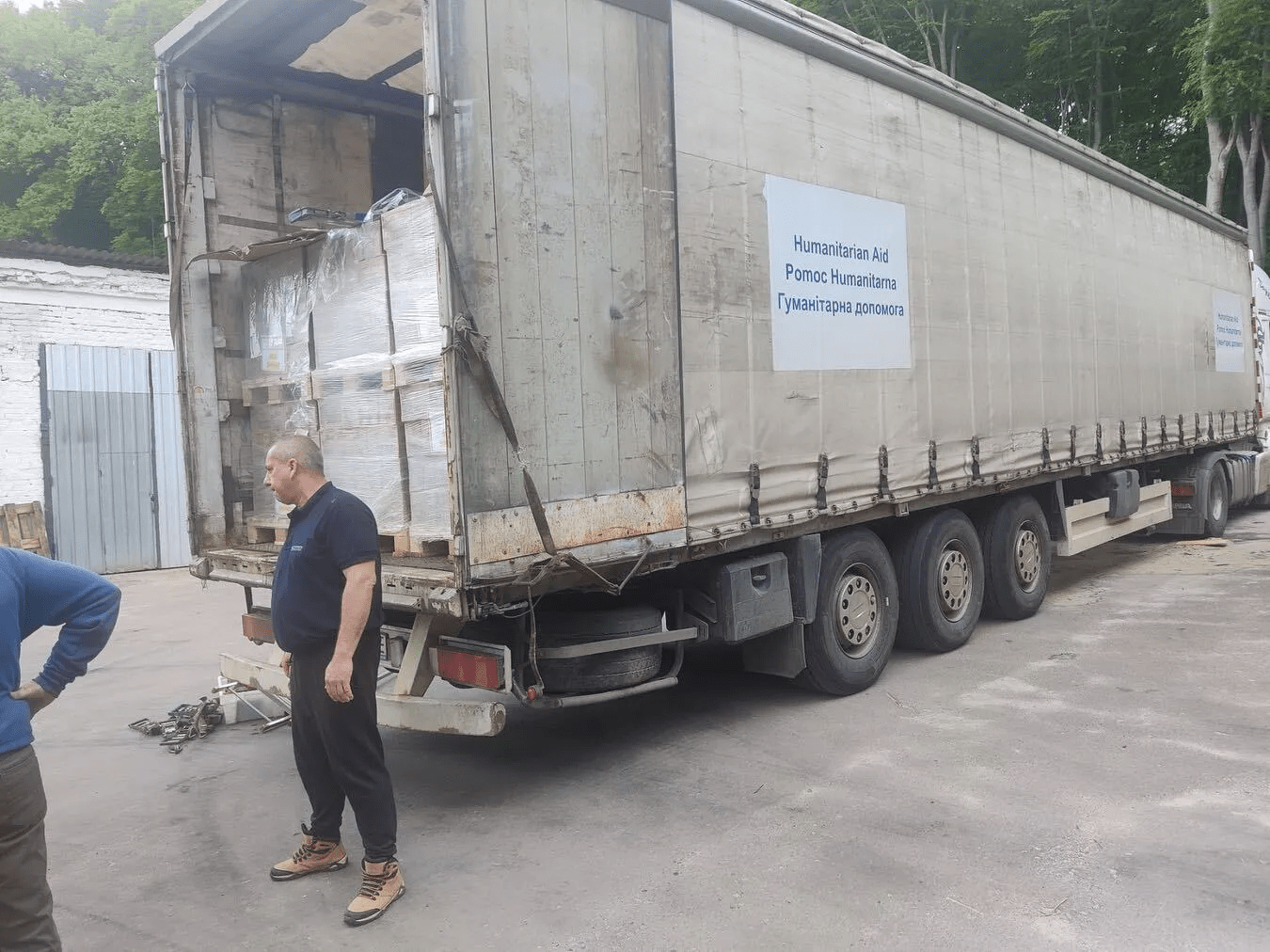 a man standing next to a large truck.
