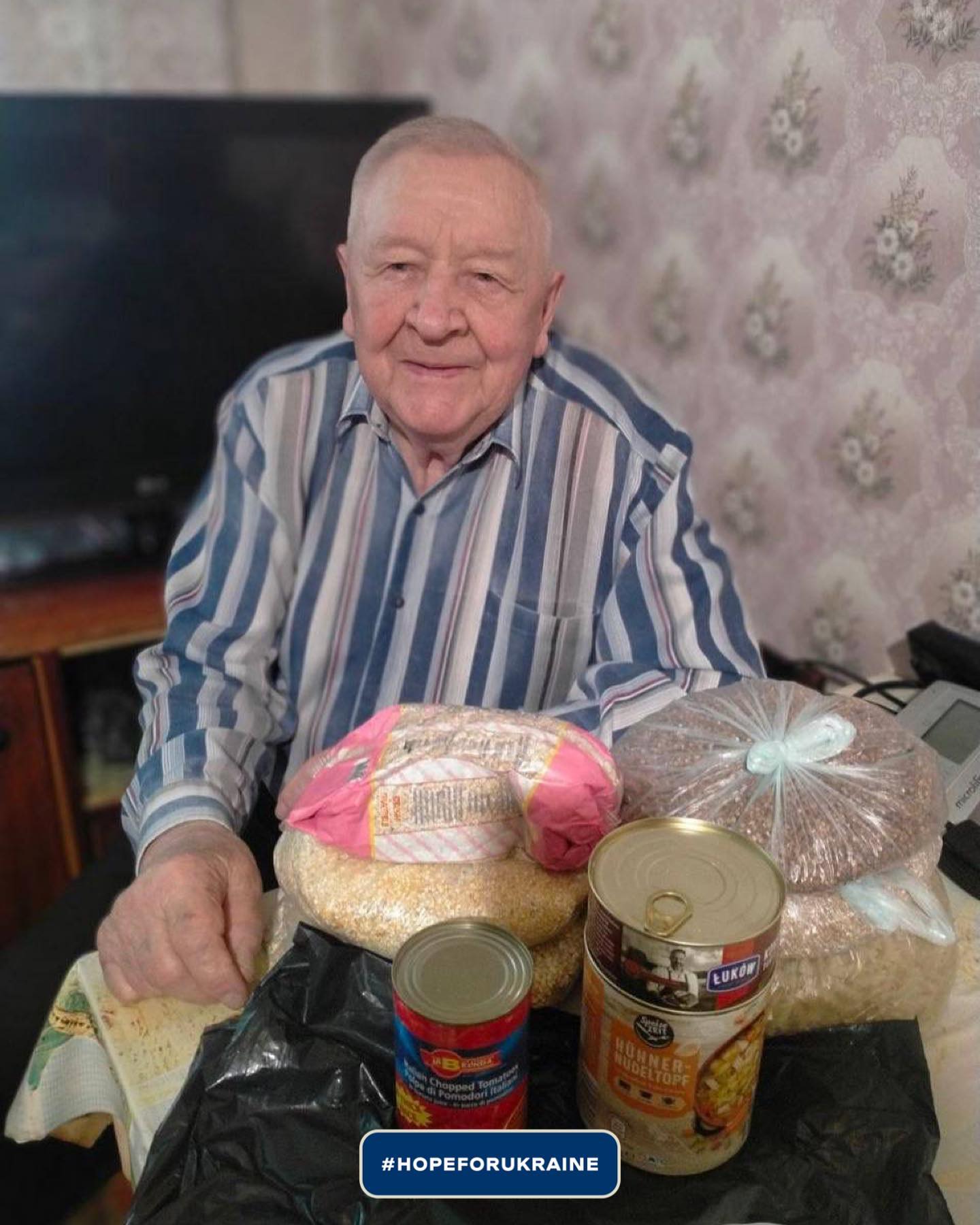 an older man sitting at a table with food.