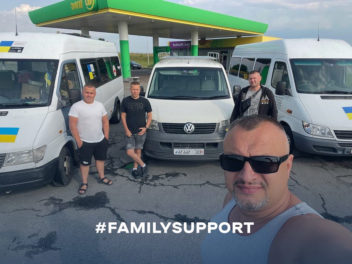a group of people standing in front of a van with the words family support.