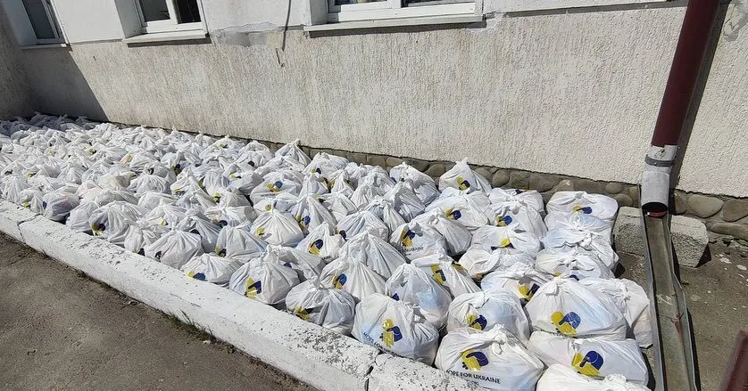 a bunch of bags of sand sitting on the side of a building.