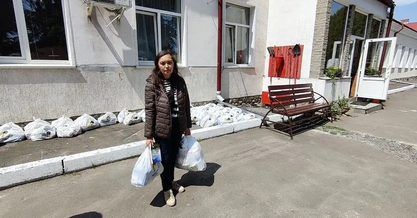 a woman holding plastic bags.
