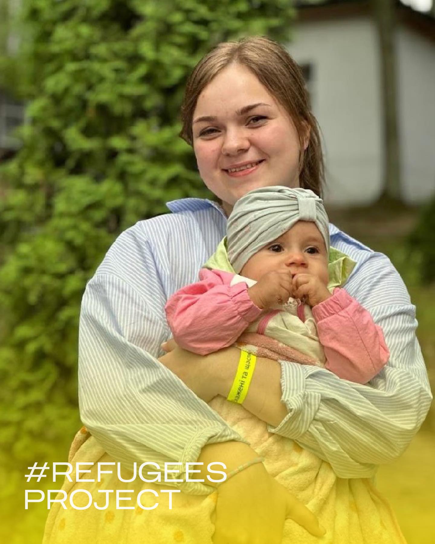 a woman holding a baby with the text refugees project.