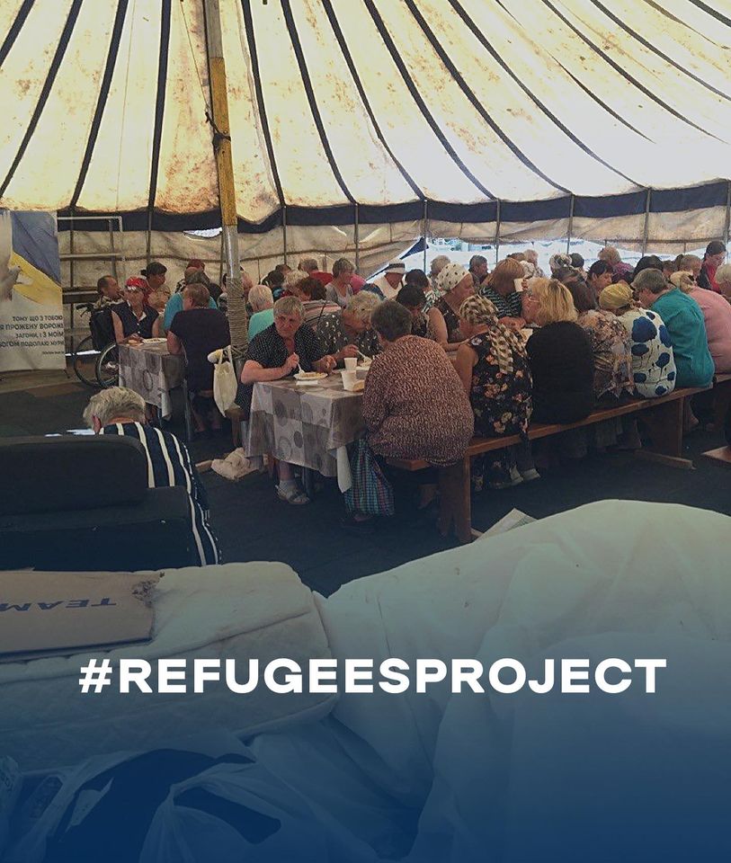 a group of people sitting in a tent with the words refugees project.