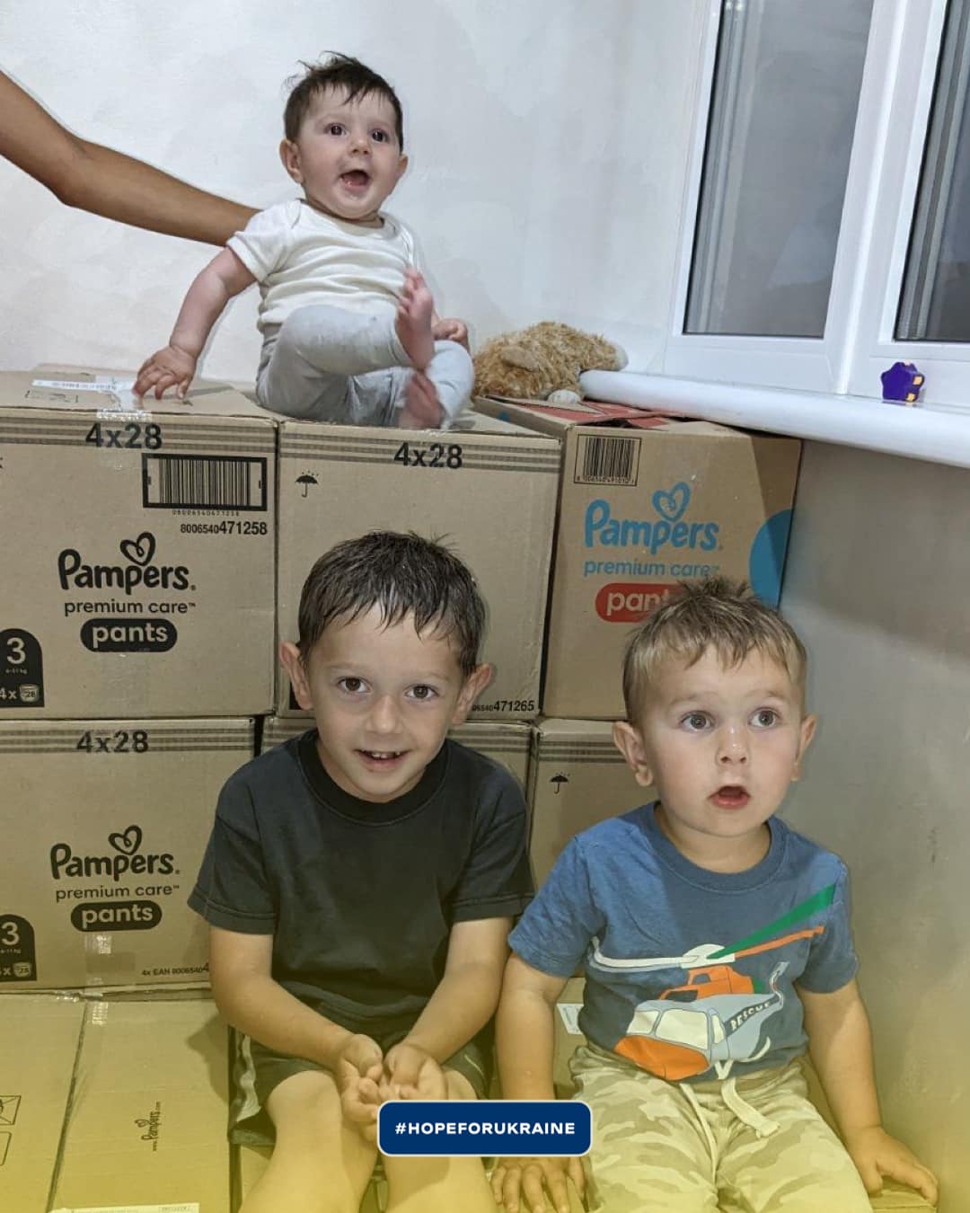 a group of children sitting on top of boxes with the text         .