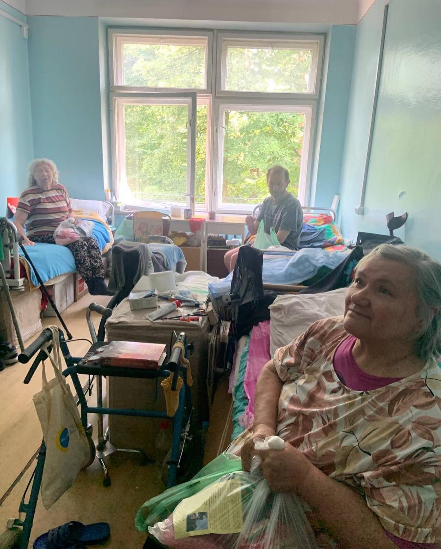 a group of elderly people sitting in a room.