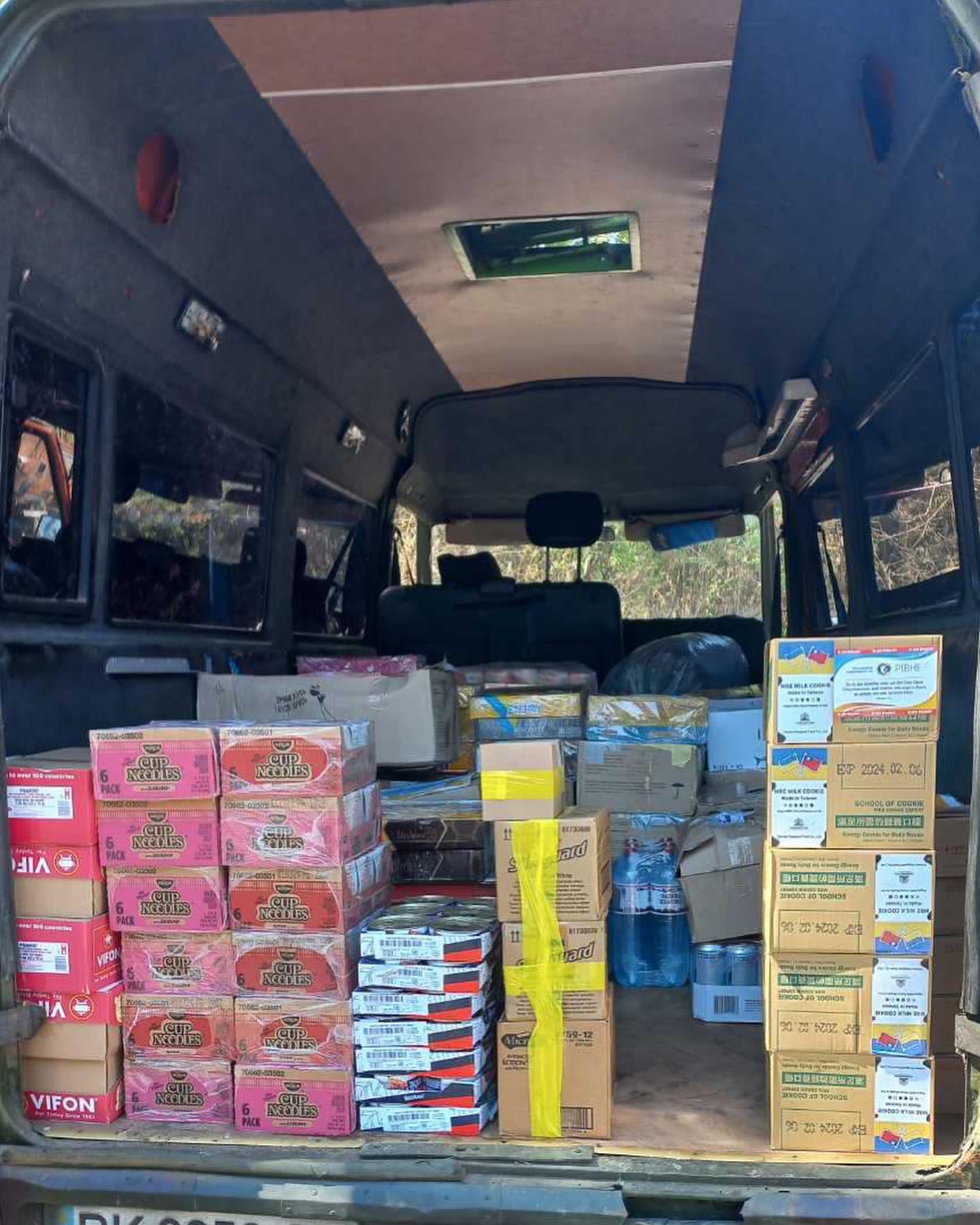 The back of a van filled with boxes of food.