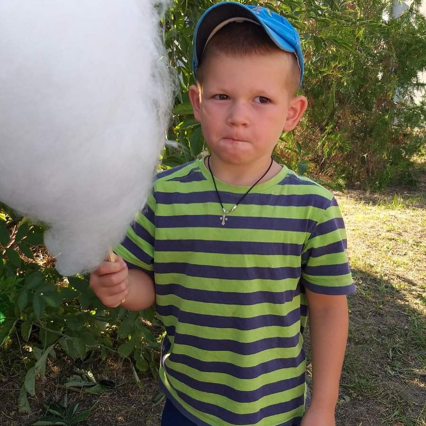 A young boy holding a cotton candy.