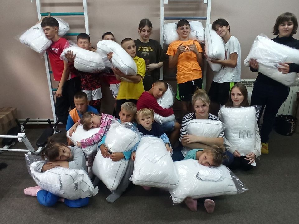 A group of children posing with pillows.