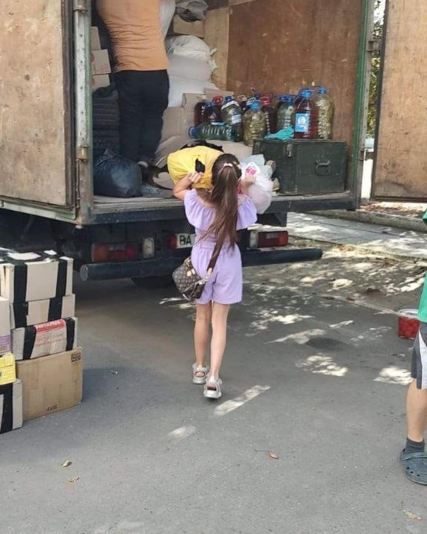 A group of people loading a truck with boxes.