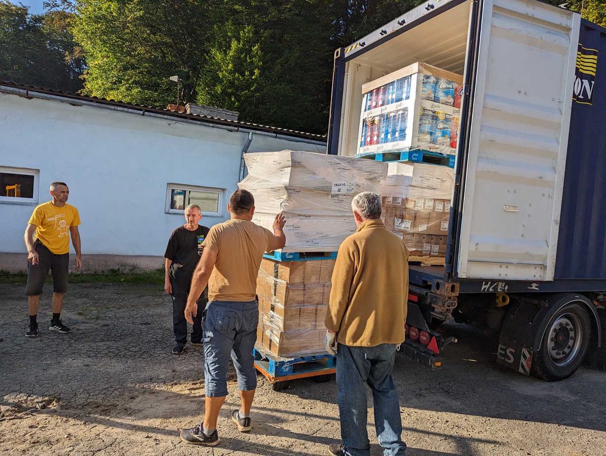 A group of men loading a truck with boxes.
