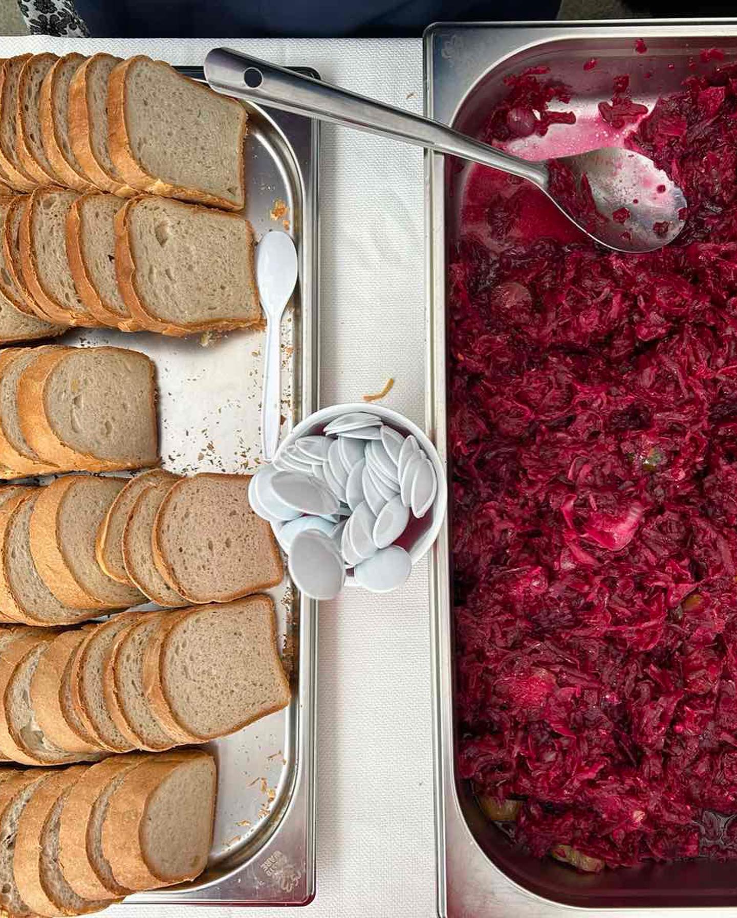 A tray of beets and bread on a table.