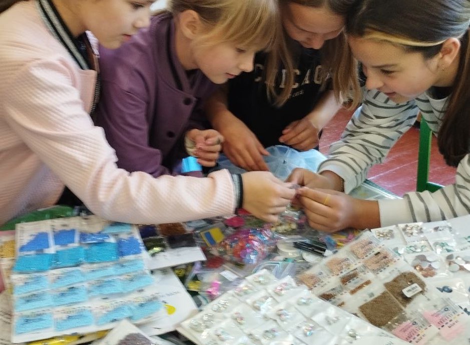 A group of girls are working together on a table.