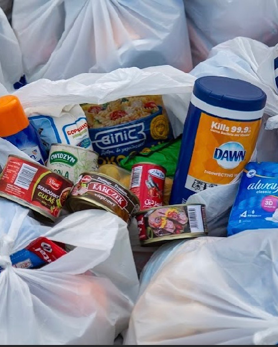 A group of plastic bags filled with food and other items.