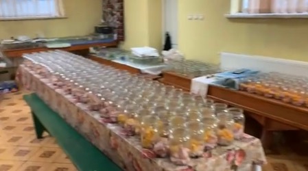 A long table filled with jars of food.