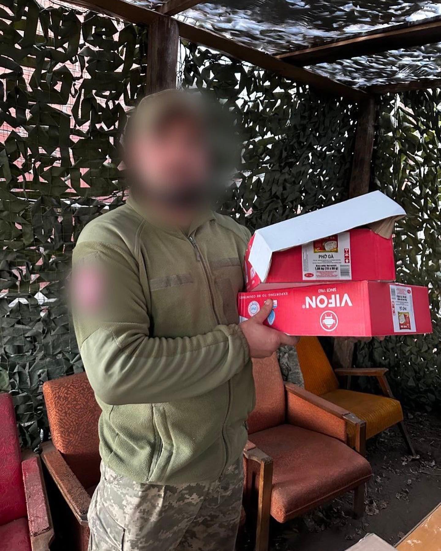 A man holding a box of nokia boxes.