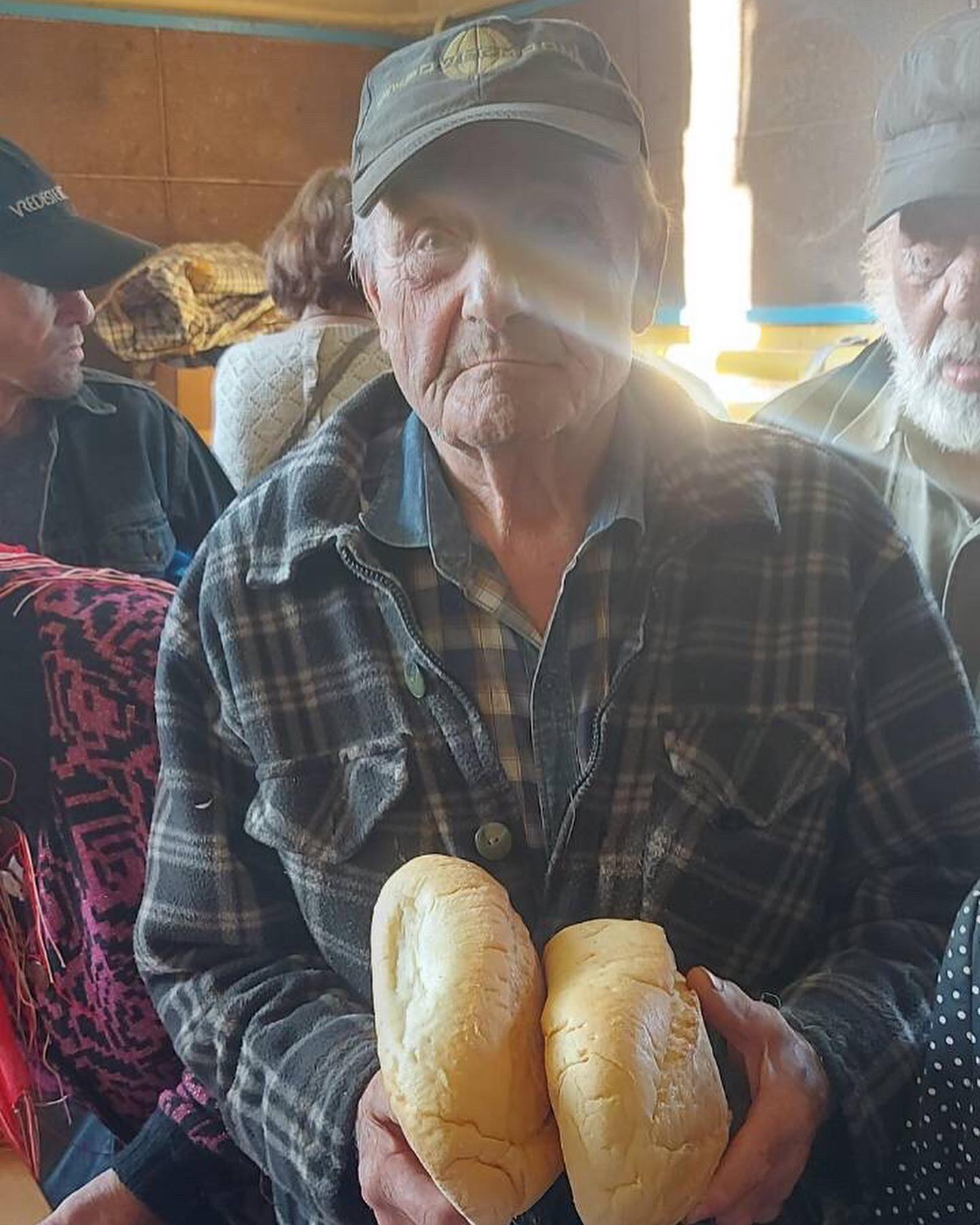 A group of people holding bread in their hands.
