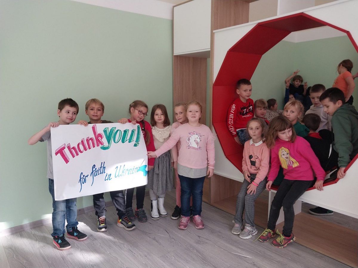 A group of children posing with a thank you sign.