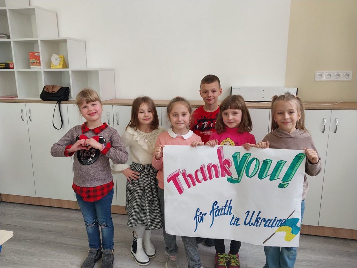 A group of children holding up a thank you sign.