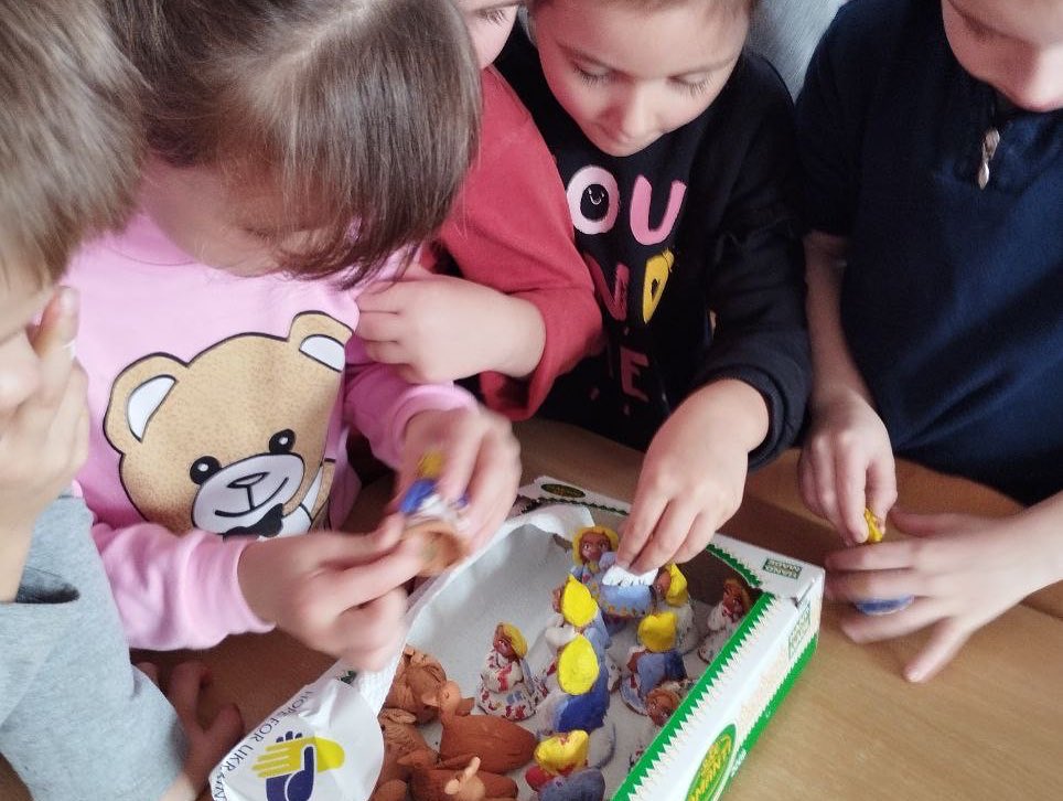 A group of children playing with toys on a table.