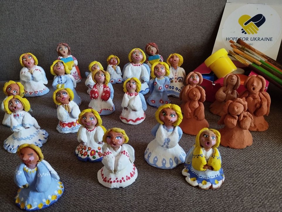 A group of clay angel figurines on a table.