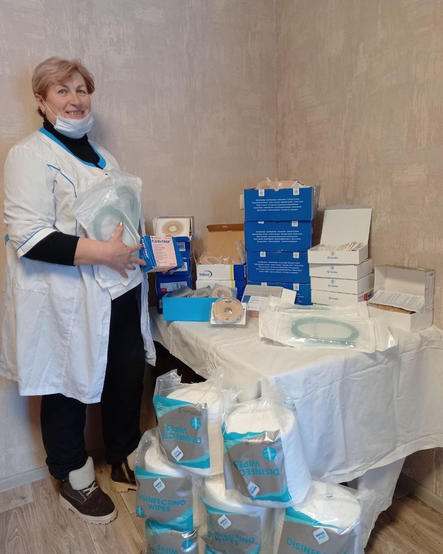 A woman standing next to a table full of medical supplies.