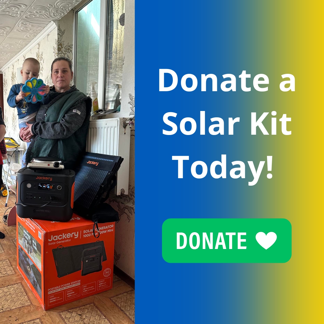 An adult holding a child stands next to a Jackery solar kit indoors; on the right, text reads "Donate a Solar Kit Today!" with a green donate button below. Learn more about our impact on the Hope For Ukraine Blog.