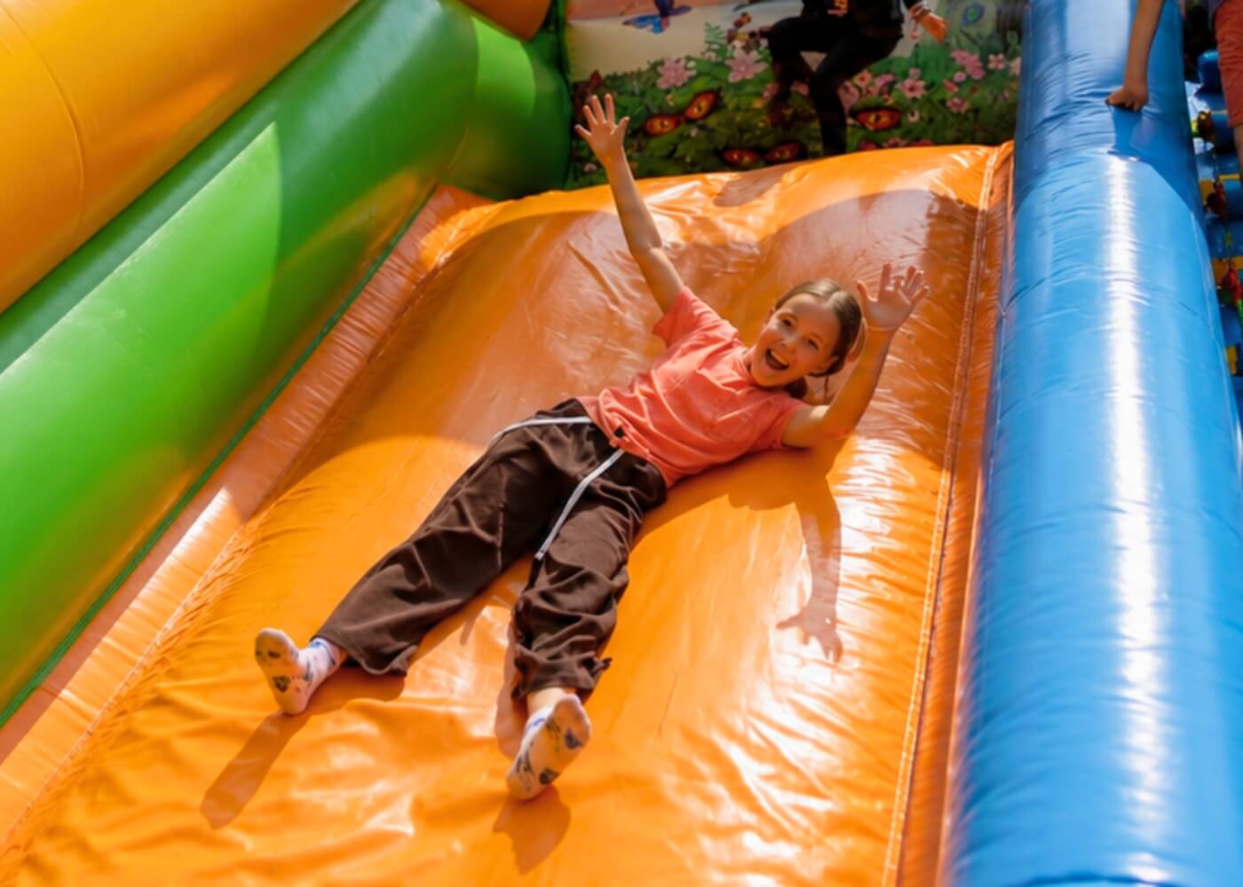 Smiling girl enjoying a bouncy house at Hope Land summer camp